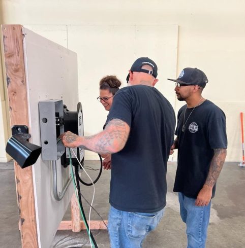 Trainees installing an EV charger